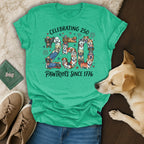 Dog graphic on a green t-shirt reading "Celebrating 250 Pawtriots Since 1776".