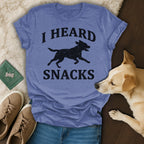 T-shirt with black silhouette of dog and text "I HEARD SNACKS".
