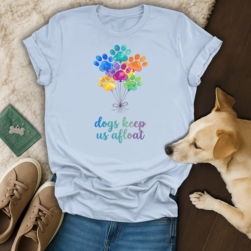 Light blue t-shirt with colorful paw print balloons and "dogs keep us afloat" text.