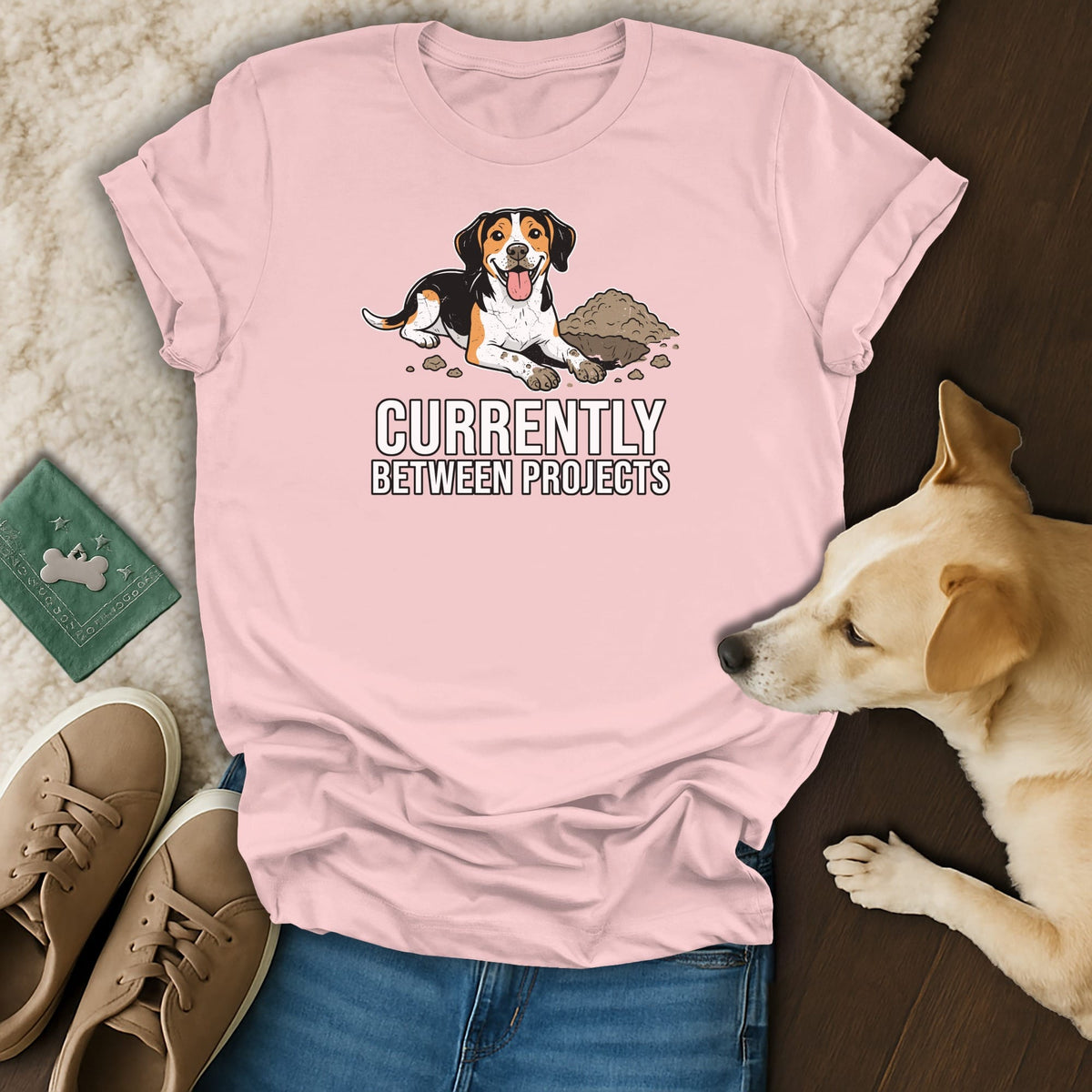 Pink t-shirt with beagle illustration and text "CURRENTLY BETWEEN PROJECTS".