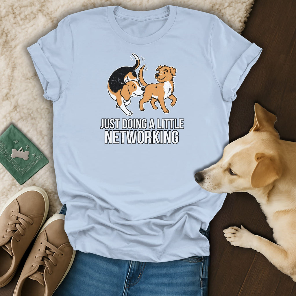 Light blue t-shirt with a graphic of two dogs and the text "JUST DOING A LITTLE NETWORKING".
