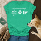 Green t-shirt with "My needs are simple," camera, paw, and film.
