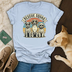 Three dogs on a t-shirt with "Rescue Squad" text and vintage sunset background.