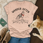 Husky wearing bandana and backpack on mountain top, text reads "Wander Often".