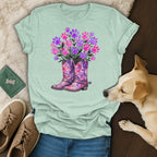 Cowboy boots filled with pink and purple paw prints and flowers.
