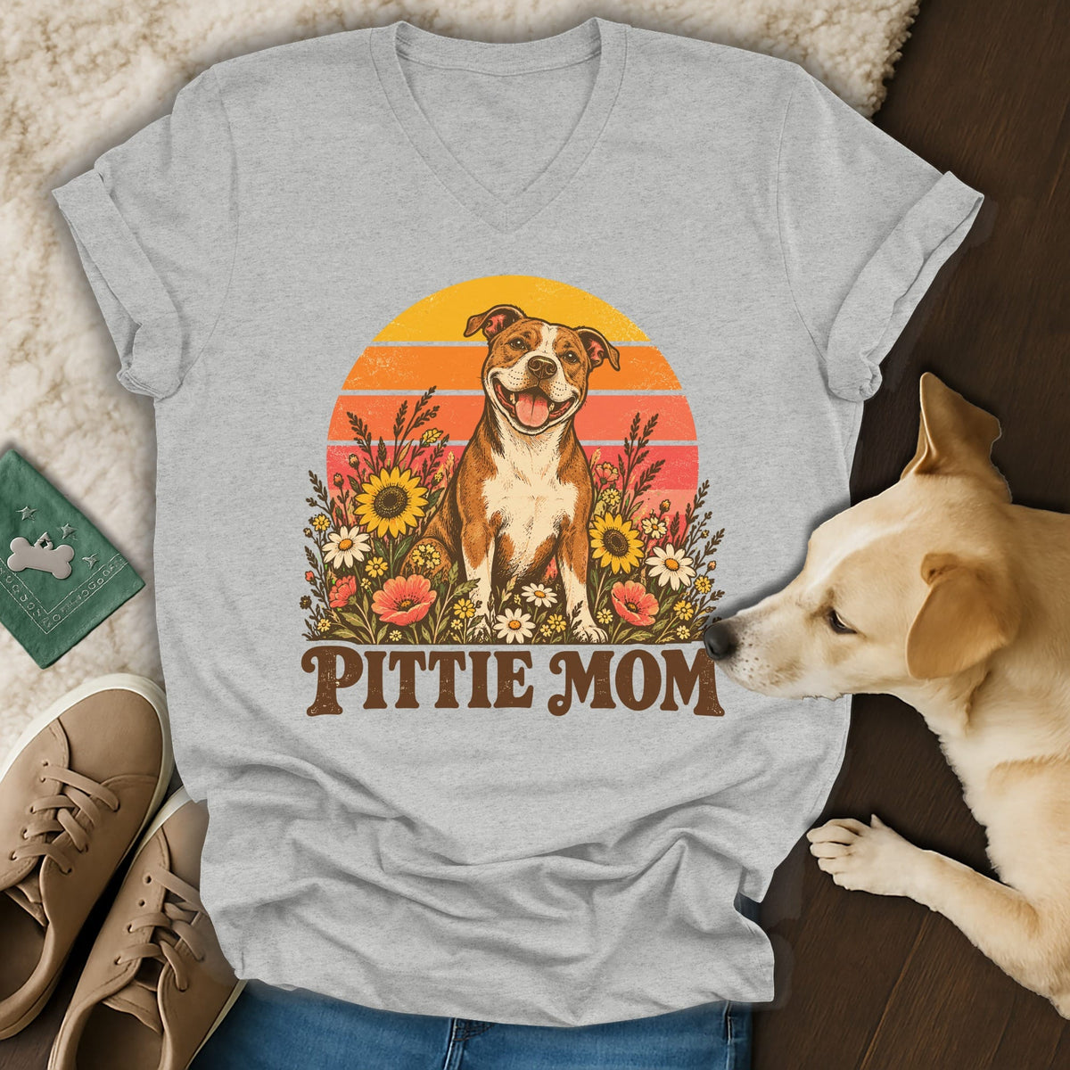 Gray v-neck t-shirt featuring a retro graphic of a pit bull surrounded by flowers with the text Pittie Mom.