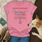 Pink t-shirt with text "She talks to her dog in full sentences" and a dog graphic.