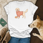 White t-shirt with a cartoon golden retriever wearing a pumpkin sweater.
