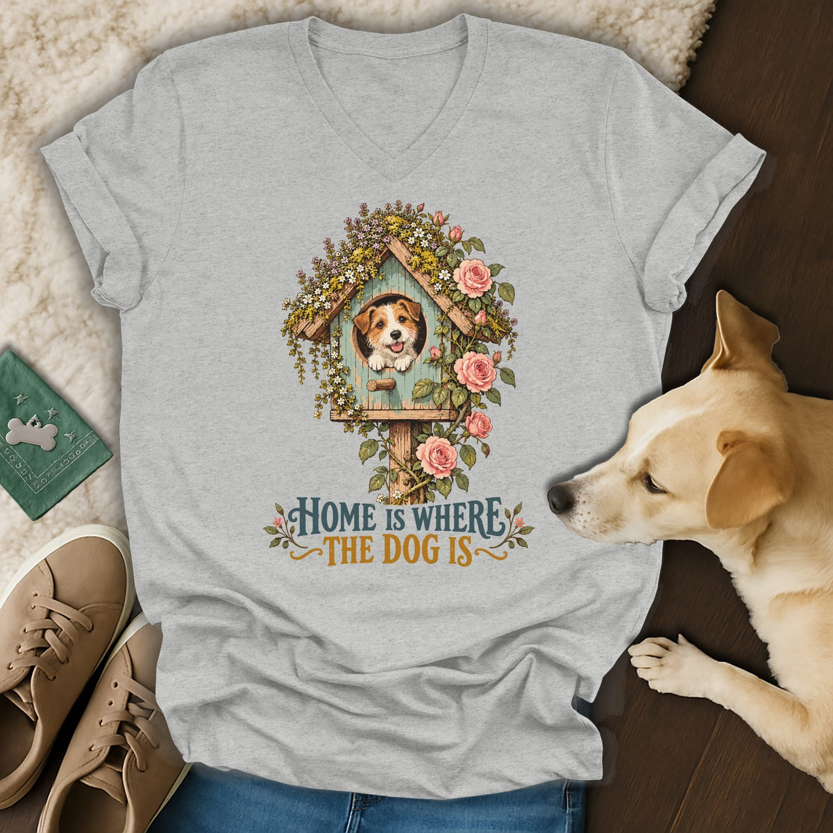 Heather gray v-neck t-shirt featuring a graphic of a puppy in a birdhouse with flowers and the text Home is where the dog is.