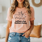 Peach t-shirt with a corgi and duck graphic and the text "ruffled a few feathers today."