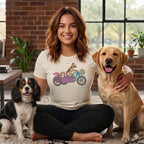 Woman with two dogs wearing a t-shirt with dogs riding a motorcycle graphic.