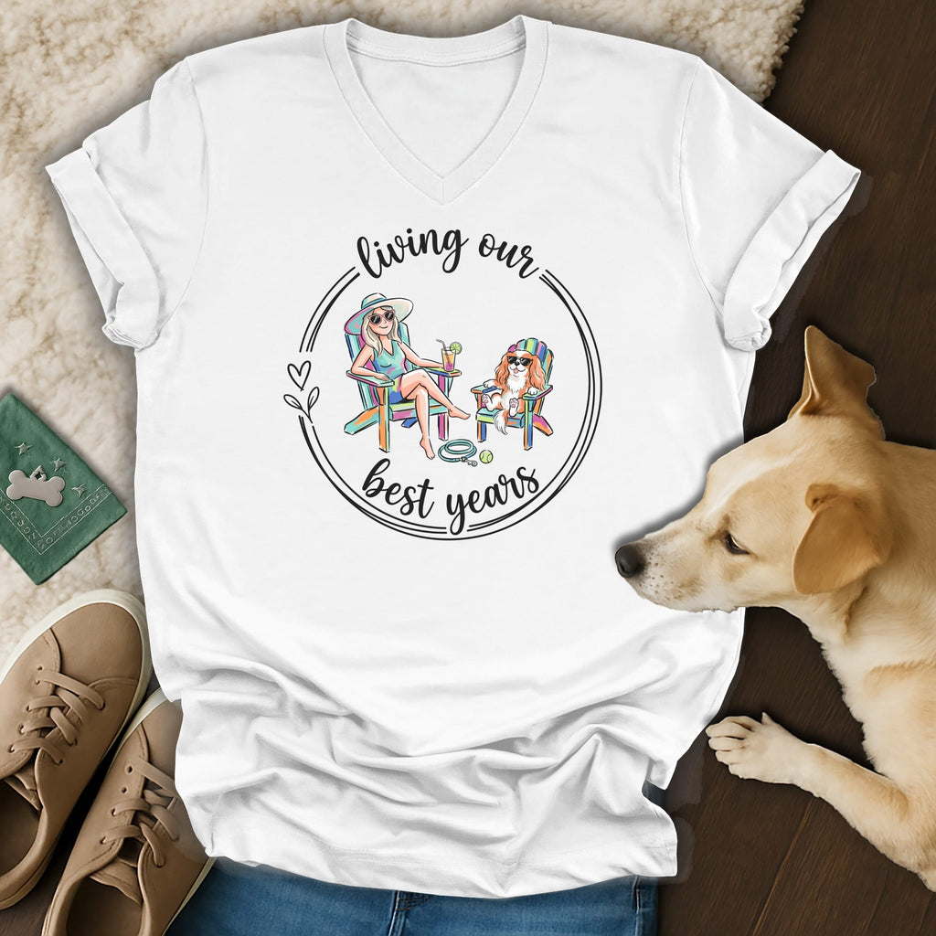 White t-shirt with graphic of woman and dog relaxing in chairs, text "living our best years".