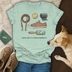 Light blue t-shirt with dog-related illustrations and text I HAVE A DOG. IT'S A WHOLE PERSONALITY.
