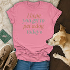 Pink t-shirt with text "I hope you get to pet a dog today" and a dog.