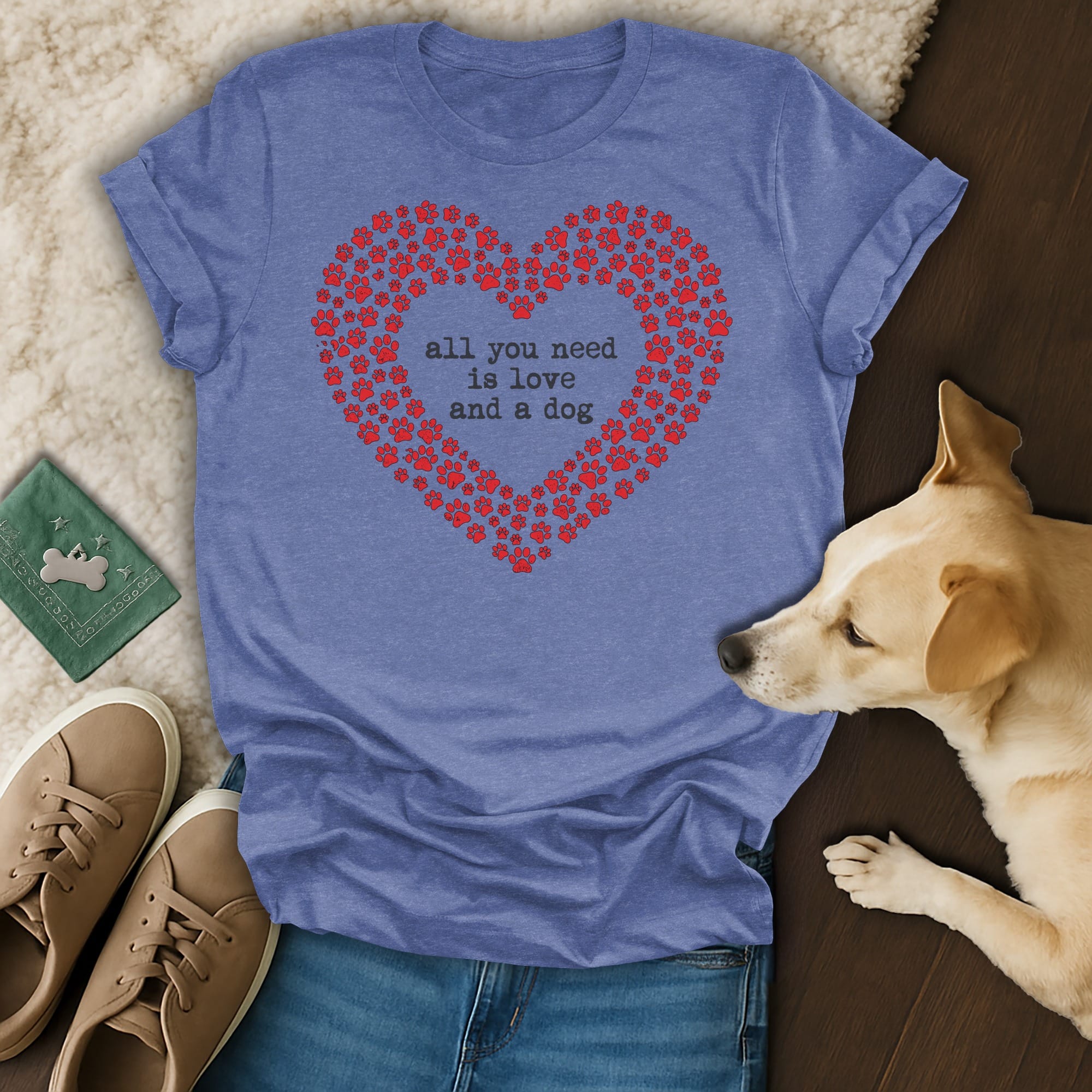 Blue t-shirt with red paw print heart and text "all you need is love and a dog".