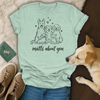 Light green t-shirt with line drawing of five dogs and text "mutts about you".