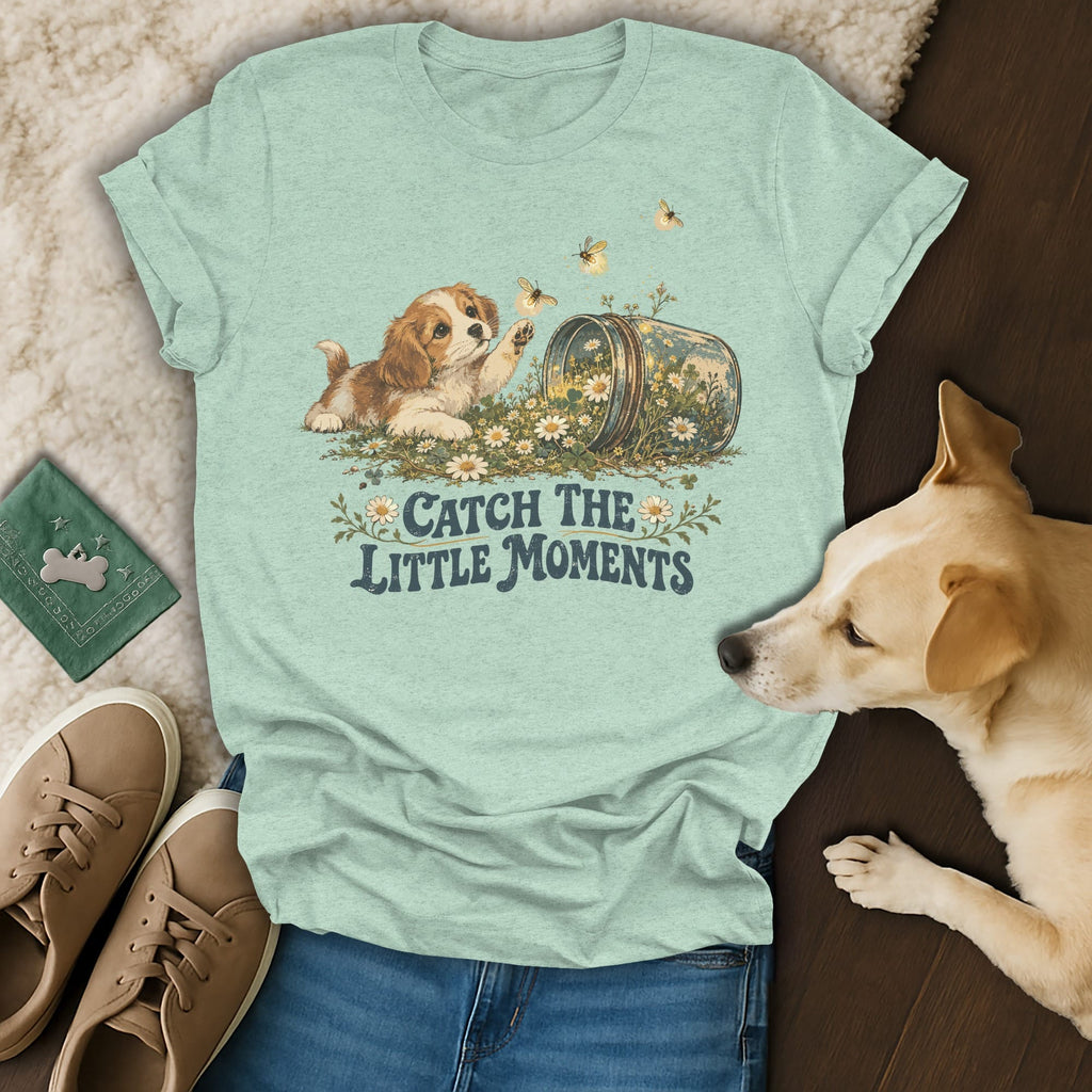 Sage green t-shirt featuring a puppy reaching for bees, with the text Catch the Little Moments.