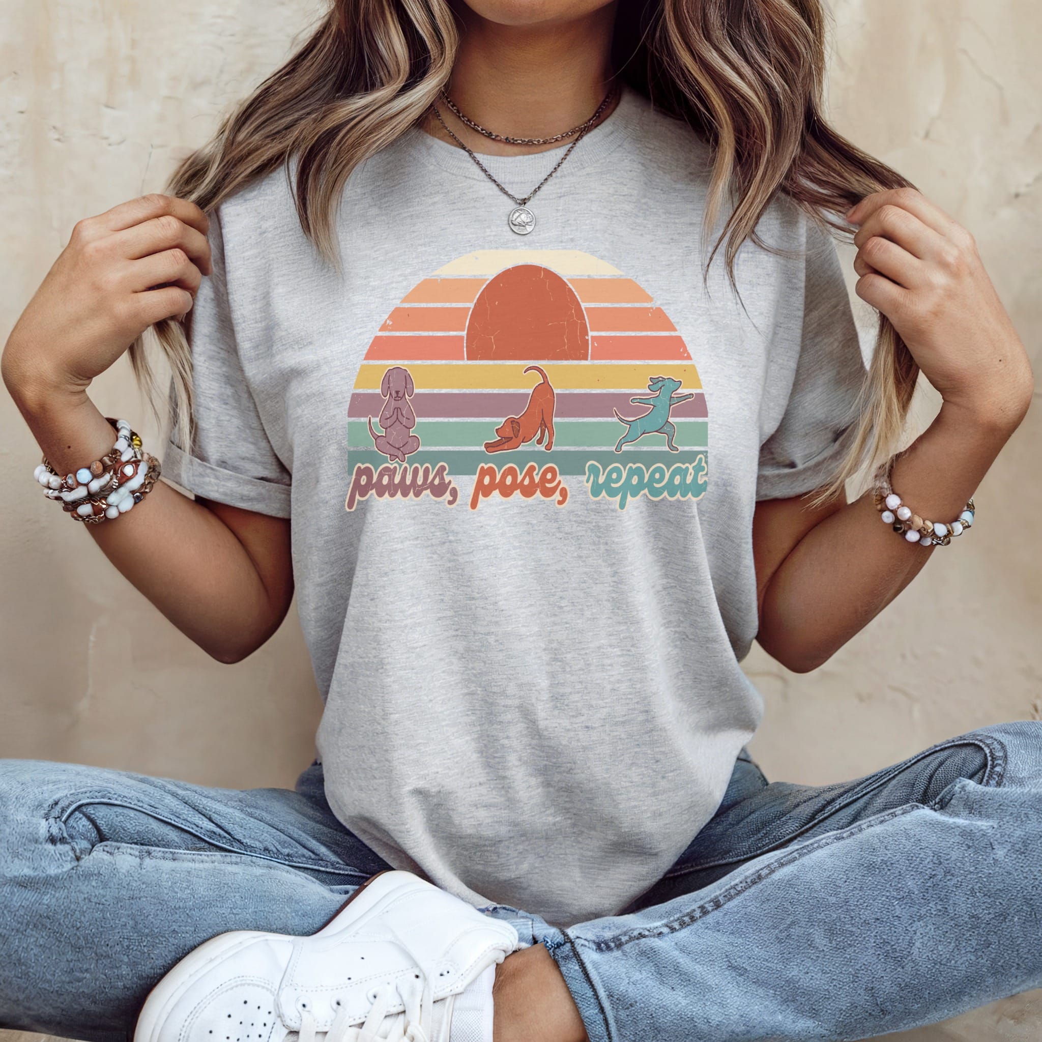 Gray t-shirt with "Paws, Pose, Repeat" yoga dog graphic and sunset.