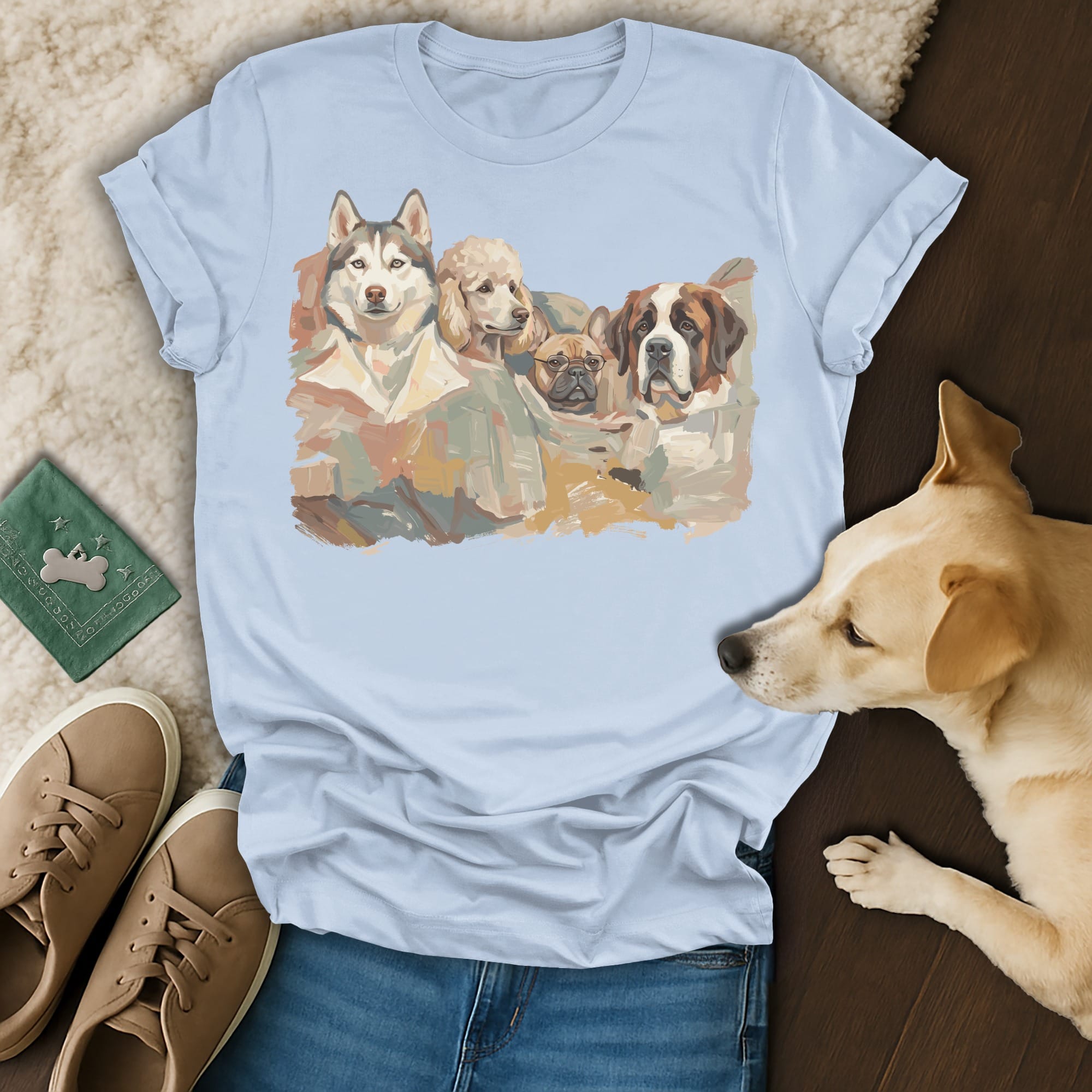 Watercolor art of four dogs on a light blue t-shirt.