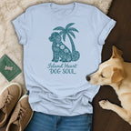Light blue t-shirt with a teal graphic of a dog and palm tree, reading "Island Heart DOG SOUL".