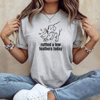 Light grey t-shirt with graphic of a dog and duck, reading "ruffled a few feathers today".