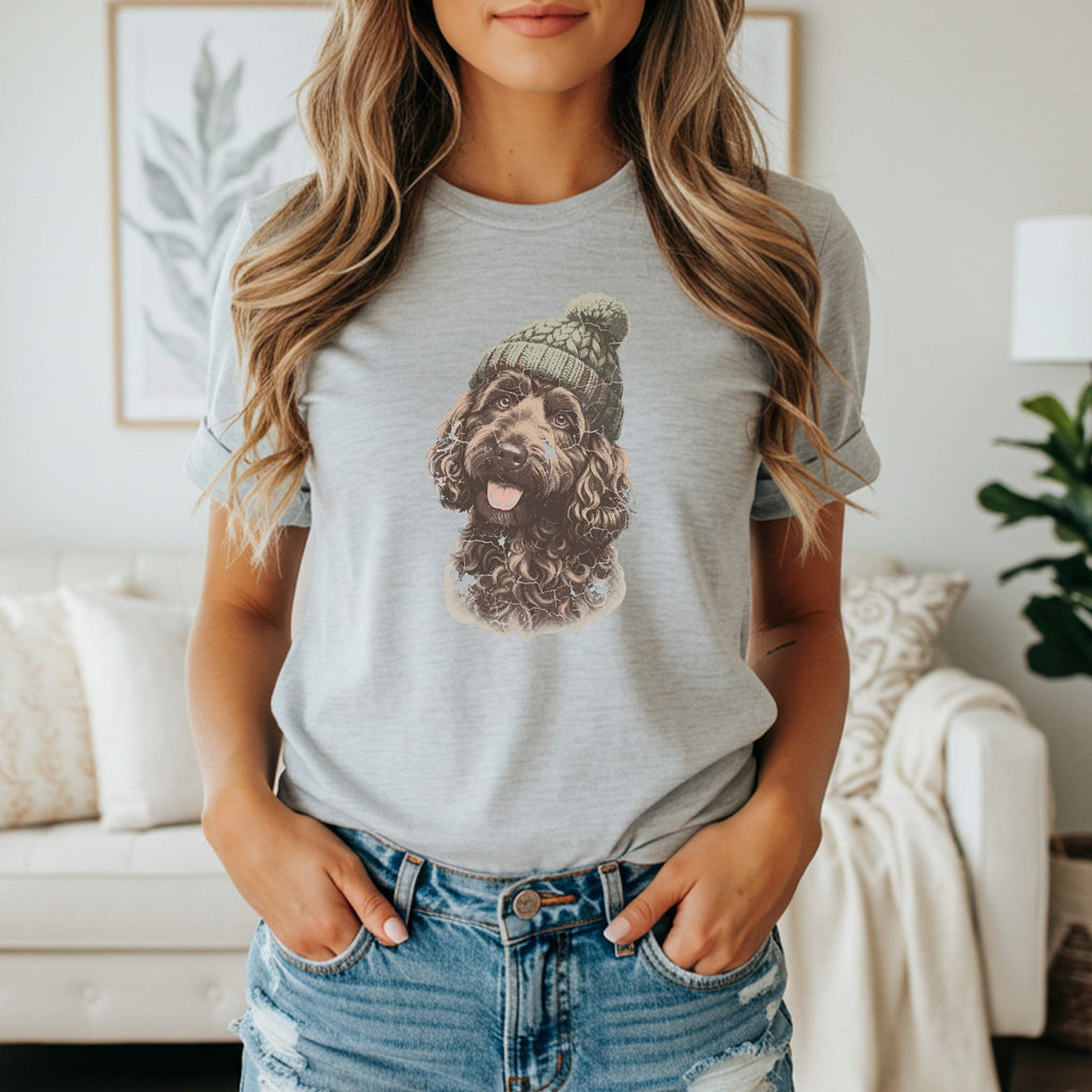 Brown dog wearing a knitted hat on a gray t-shirt.