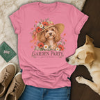 Pink t-shirt featuring a graphic of a curly dog in a flower hat and the text "Garden Party."
