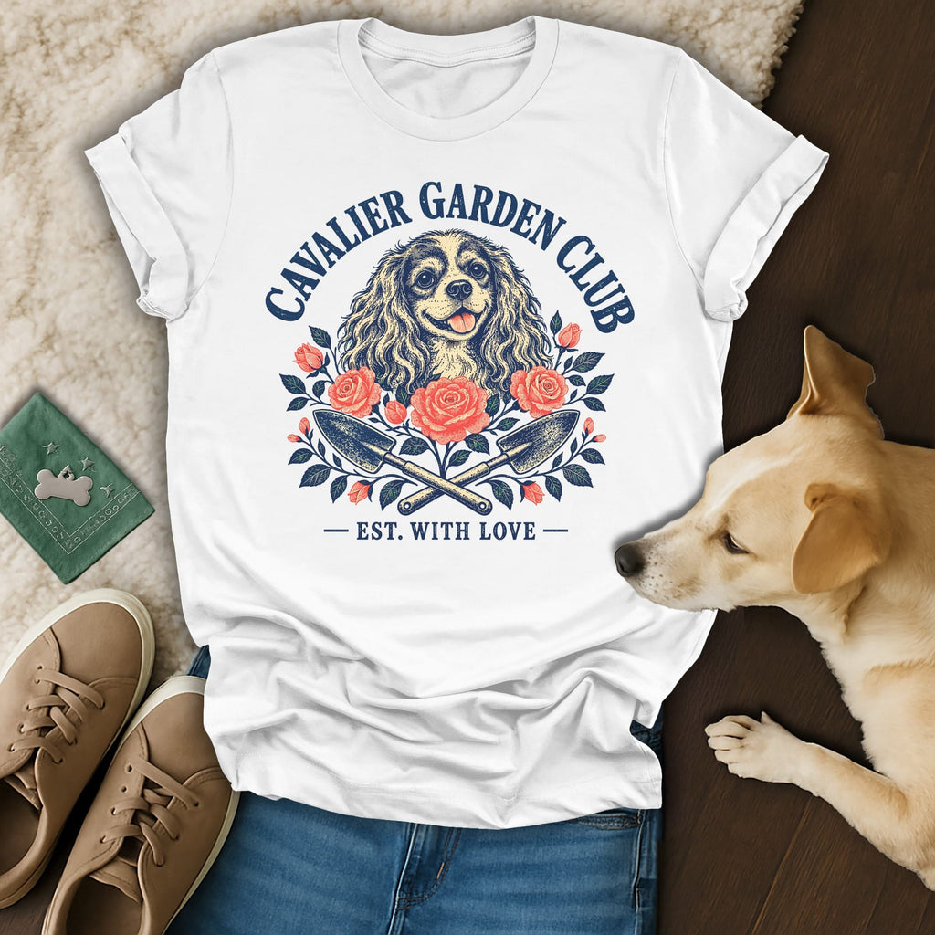 White t-shirt with a vintage Cavalier Garden Club graphic featuring a dog, roses, and crossed garden trowels.
