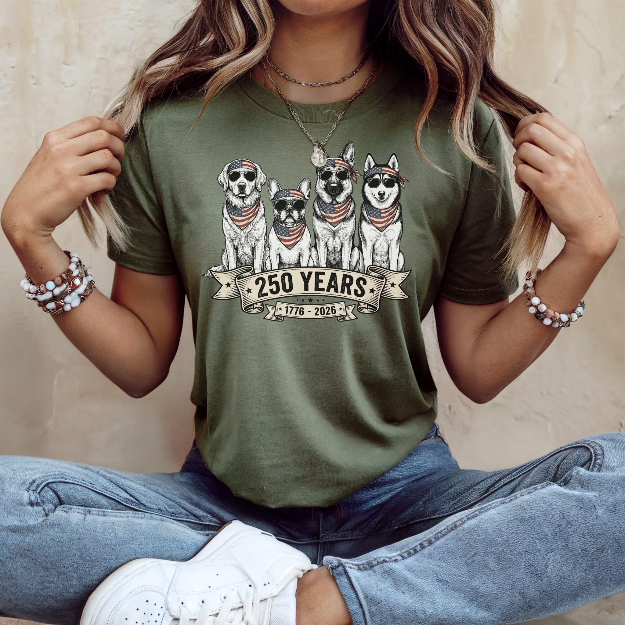 Olive green t-shirt with dogs wearing bandanas and "250 Years 1776-2026" text.