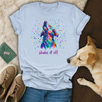 Colorful abstract dog head graphic with "shake it off" text on a light blue t-shirt.