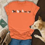 Orange t-shirt with cartoon dogs dressed as ghosts for Halloween.