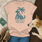 Peach t-shirt with teal dog, palm tree, and text "Island Heart DOG SOUL".