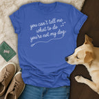 Blue t-shirt with white text "you can't tell me what to do you're not my dog".