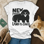 T-shirt with black silhouette of a dog and text "NEW FOUND LAND ON THE COUCH".