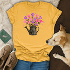 Yellow t-shirt with watering can and pink paw print flowers.