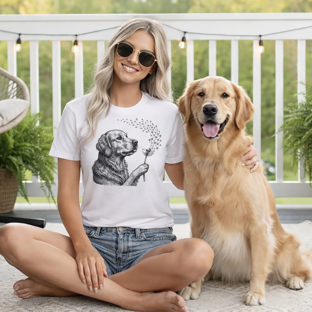 Woman wearing a t-shirt with a dog holding dandelions, sitting with a golden retriever.
