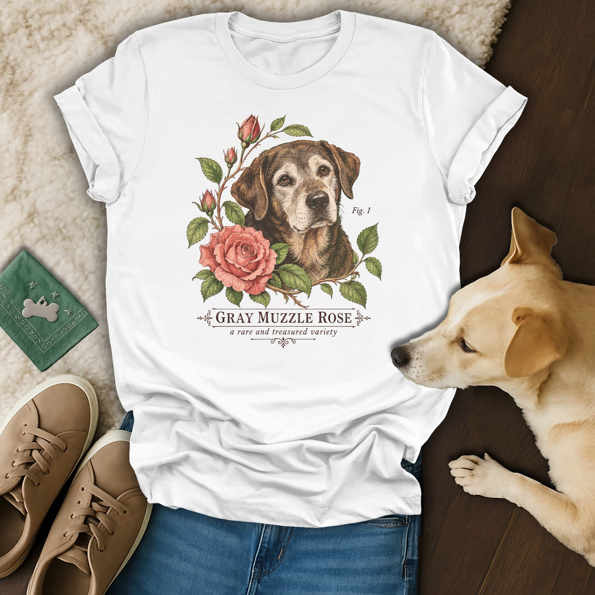 A white t-shirt featuring a botanical illustration of a senior dog and roses with the text Gray Muzzle Rose.