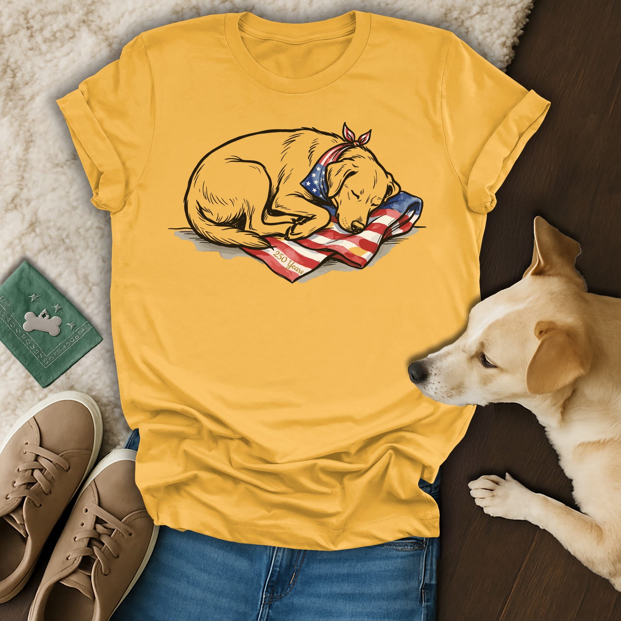 Yellow t-shirt with a sleeping dog wearing a bandana on an American flag.