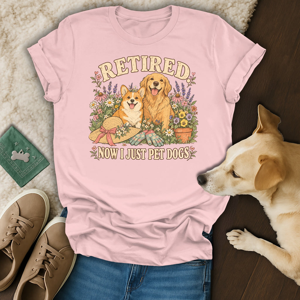 Pink t-shirt with a graphic of a corgi and golden retriever surrounded by flowers, reading Retired Now I Just Pet Dogs.