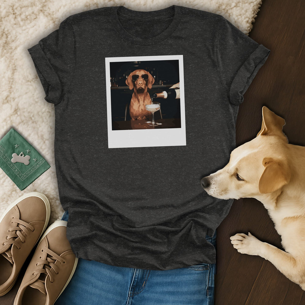 T-shirt graphic of a dog in sunglasses being served champagne at a bar.