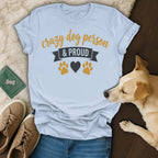 Light blue t-shirt with "Crazy Dog Person & Proud" text and paw print design.
