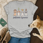 Grey t-shirt with four dogs wearing mushroom hats and text "SHROOMIN' & groomin'".