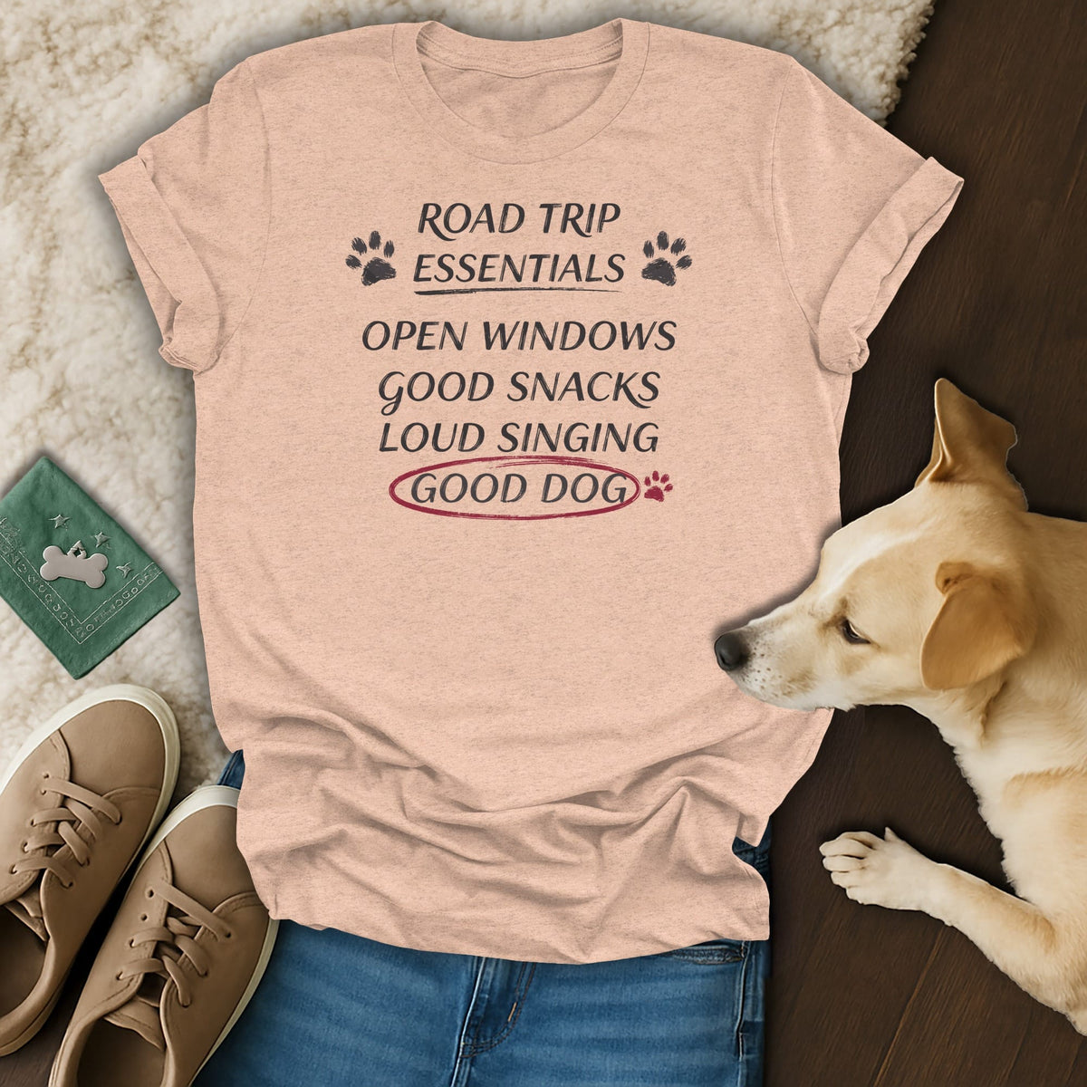 Peach t-shirt with "Road Trip Essentials" and dog paw print design.
