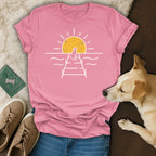 Pink t-shirt with a dog silhouette on a pier at sunset.
