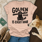T-shirt with black text "GOLDEN HOUR IS EVERY HOUR" and a dog silhouette holding a stick.