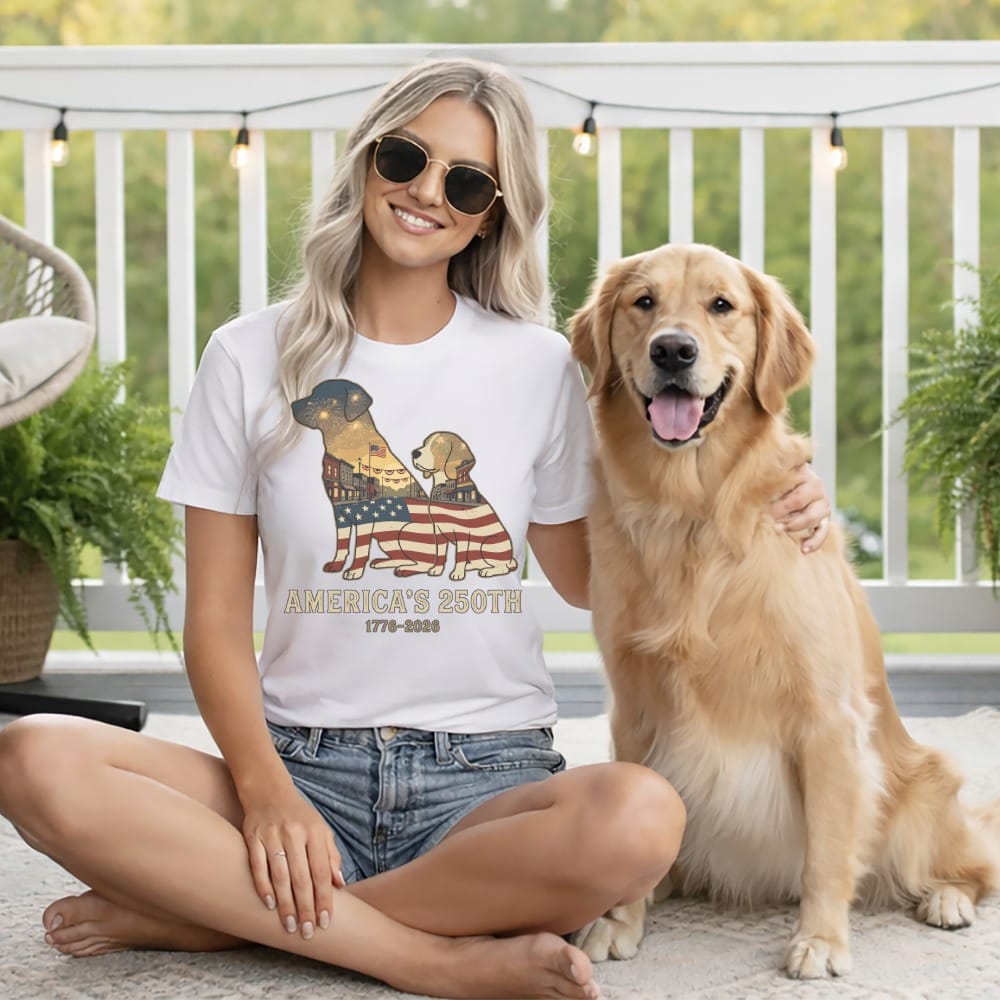 Woman wearing white t-shirt with American flag and dog graphic, Golden Retriever on lap.