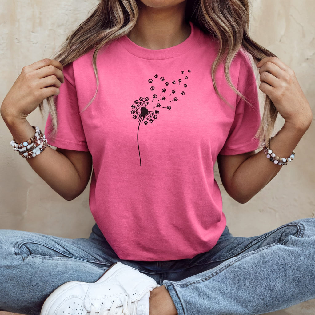 Pink t-shirt with a black dandelion and paw print design.