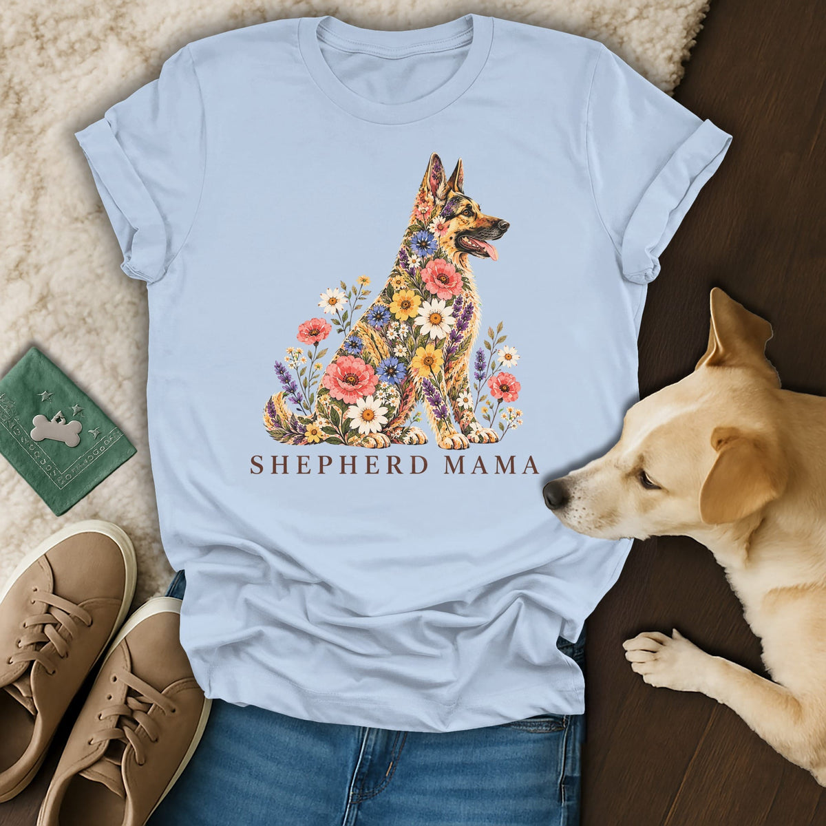 A light blue t-shirt printed with a floral German Shepherd illustration and the text Shepherd Mama.