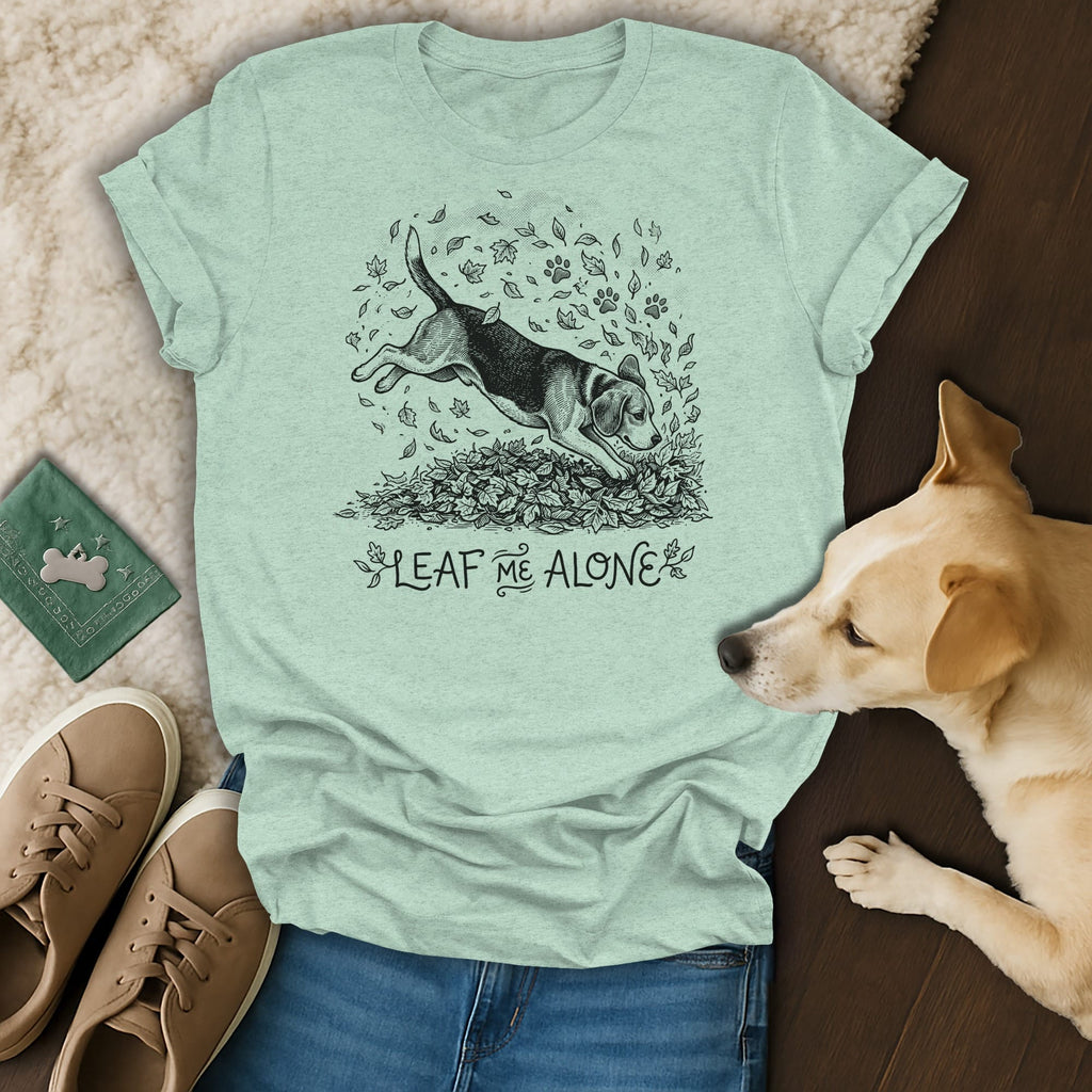 Light green t-shirt with a beagle dog illustration jumping in leaves, text "LEAF ME ALONE".