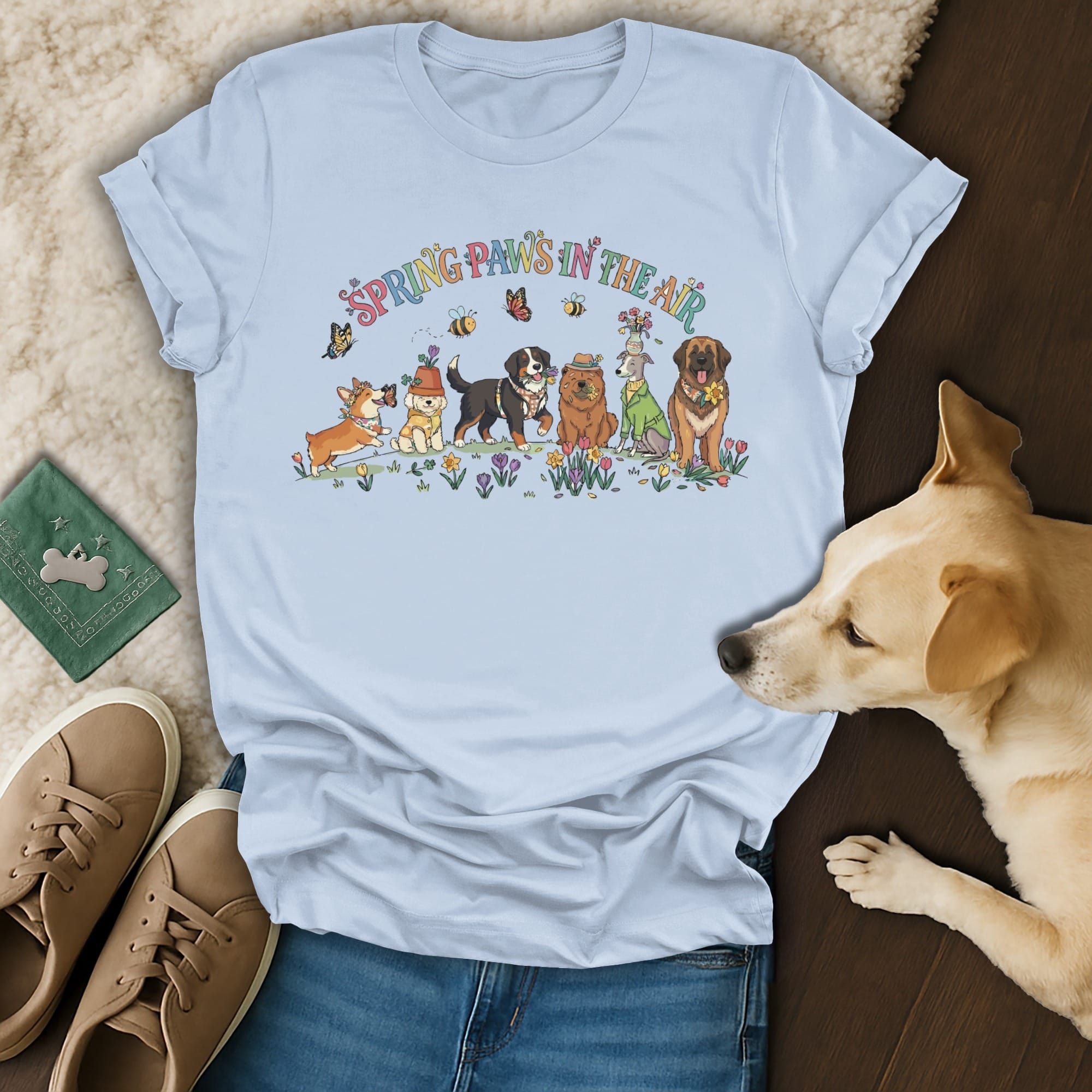 Light blue t-shirt with cartoon dogs and "Spring Paws in the Air" text.